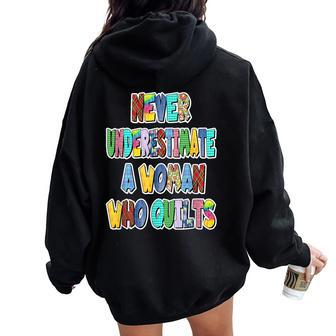 Never Underestimate A Woman Who Quilts Patchwork Letters Women Oversized Hoodie Back Print - Monsterry