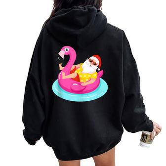 Christmas In July Santa Relaxing On A Flamingo Float Women Oversized Hoodie Back Print - Monsterry
