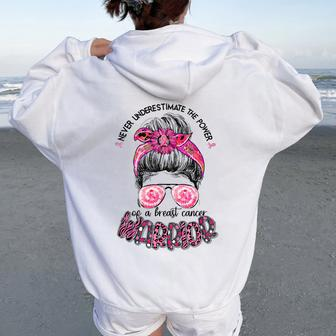 Never Underestimate Breast Cancer Warrior Messy Bun Ribbon Women Oversized Hoodie Back Print - Seseable