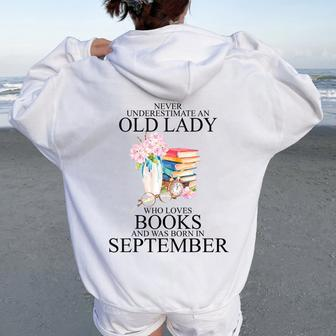 Never Underestimate An Old Lady Who Loves Books September Women Oversized Hoodie Back Print | Mazezy