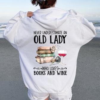 Never Underestimate An Old Lady Who Loves Books And Wine Women Oversized Hoodie Back Print | Mazezy