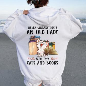 Never Underestimate An Old Lady Who Loves Cats And Books Women Oversized Hoodie Back Print | Mazezy