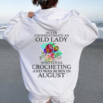 Never Underestimate An Old Lady Who Loves Crocheting August Women Oversized Hoodie Back Print | Mazezy