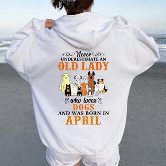 Never Underestimate An Old Lady Loves Dogs Born In April Women Oversized Hoodie Back Print | Mazezy