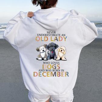 Never Underestimate Old Lady Loves Dogs Born In December Women Oversized Hoodie Back Print - Seseable
