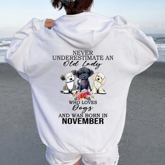 Never Underestimate An Old Lady Who Loves Dogs-November Women Oversized Hoodie Back Print | Mazezy