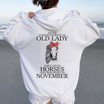 Never Underestimate An Old Lady Who Loves Horses November Women Oversized Hoodie Back Print - Seseable