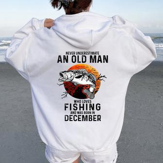 Never Underestimate An Old Man Loves Fishing December Women Oversized Hoodie Back Print - Thegiftio UK