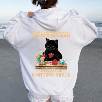 Never Underestimate An Old Woman With Cat And Knitting Women Oversized Hoodie Back Print | Mazezy CA