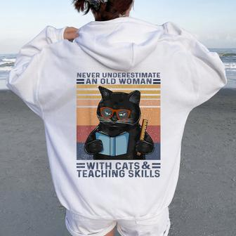 Never Underestimate An Old Woman With Cats & Teaching Skills Women Oversized Hoodie Back Print - Thegiftio UK