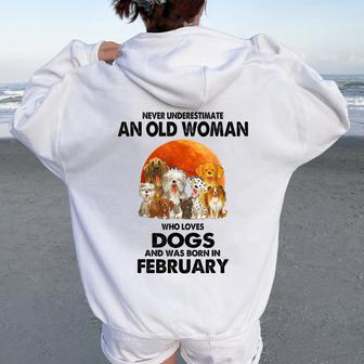 Never Underestimate An Old Woman Who Loves Dogs February Women Oversized Hoodie Back Print - Thegiftio UK