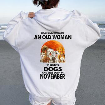 Never Underestimate An Old Woman Who Loves Dogs November Women Oversized Hoodie Back Print - Thegiftio UK