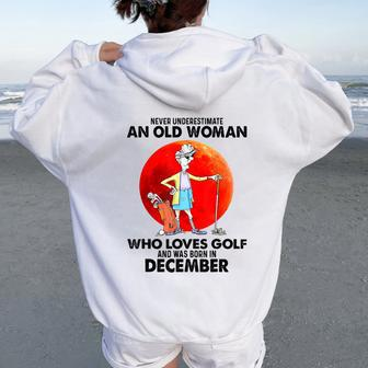 Never Underestimate An Old Woman Who Loves Golfs December Women Oversized Hoodie Back Print - Seseable
