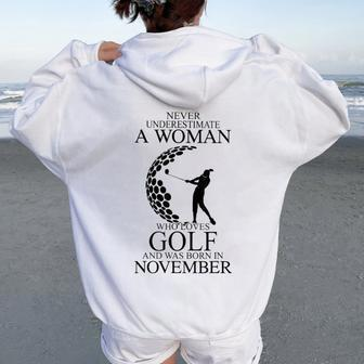 Never Underestimate A Woman Who Loves Golf Was Born November Women Oversized Hoodie Back Print | Mazezy