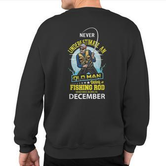 Never Underestimate Old Man With A Fishing Rod Born In Dec Sweatshirt Back Print - Seseable