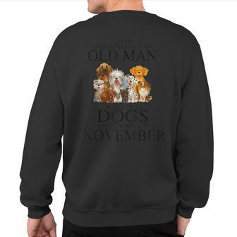 Never Underestimate An Old Man Who Loves Dogs In November Sweatshirt Back Print - Seseable