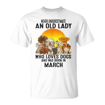 Never Underestimate An Old March Lady Who Loves Dogs Pet T-Shirt - Seseable