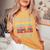 Vintage Never Underestimate An Old Woman Who Loves Soccer Women's Oversized Comfort T-Shirt Mustard