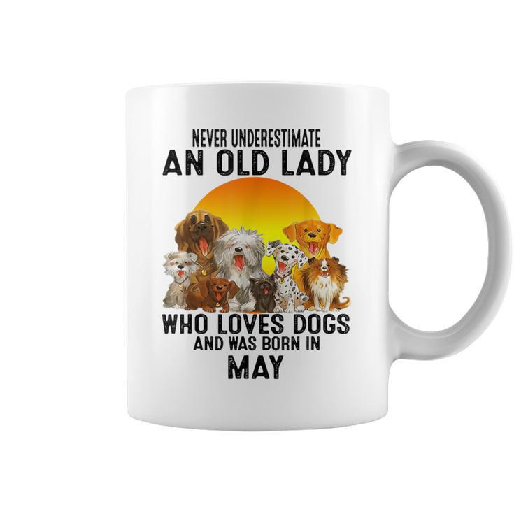 Never Underestimate An Old May Lady Who Loves Dogs Coffee Mug