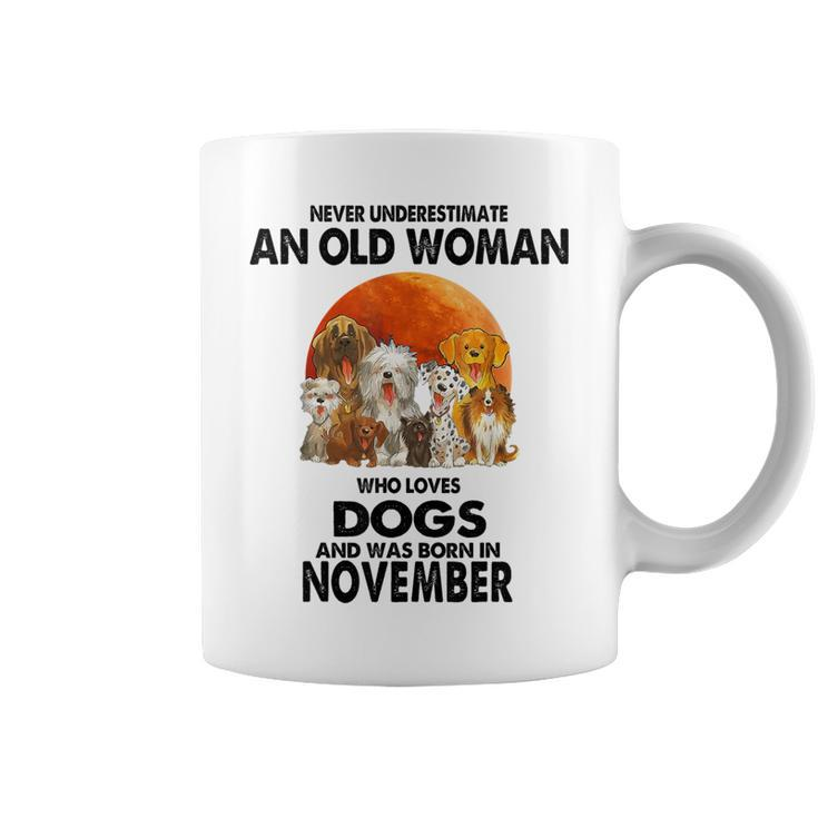 Never Underestimate An Old Woman Who Loves Dogs November Coffee Mug