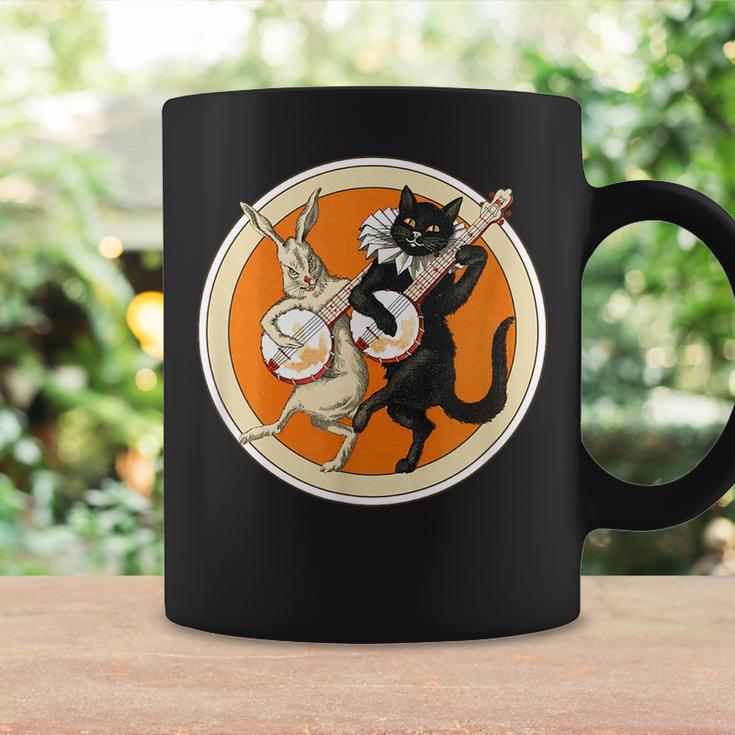 https://i3.cloudfable.net/styles/735x735/128.138/Black/the-black-cat-magazine-halloween-cat-rabbit-and-banjo-gifts-for-rabbit-lovers-funny-gifts-coffee-mug-20230712121016-zo4504vz.jpg