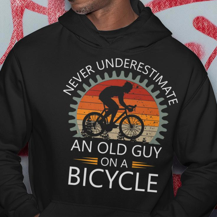 An Old Guy On A Bicycle Cycling Vintage Never Underestimate Cycling Funny Gifts Hoodie Unique Gifts