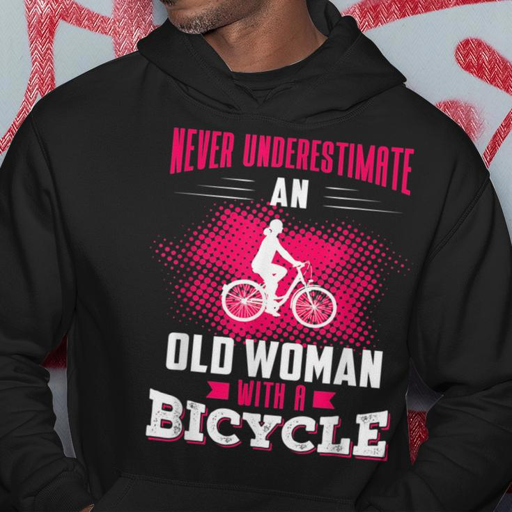 Never Underestimate An Old Woman With A Bicycle Pink Old Woman Funny Gifts Hoodie Unique Gifts