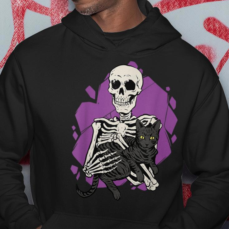 Skeleton Holding A Black Cat Lazy Halloween Costume Skull Hoodie Unique Gifts