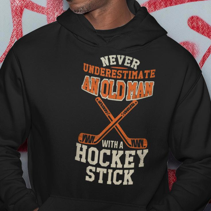 Never Underestimate An Old Man With A Stick Old Man Hockey Hoodie Funny Gifts