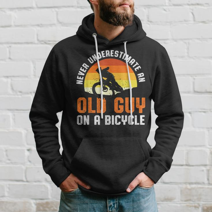 Never Underestimate An Old Guy On A Bicycle Funny Riders Dad Hoodie Gifts for Him