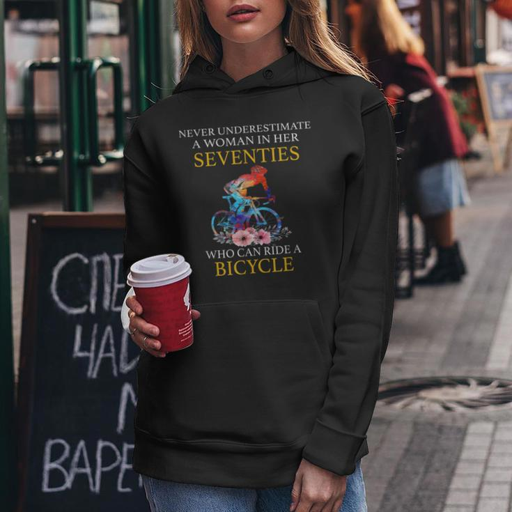 Never Underestimate Woman In Her Seventies Rides A Bicycle Women Hoodie Funny Gifts