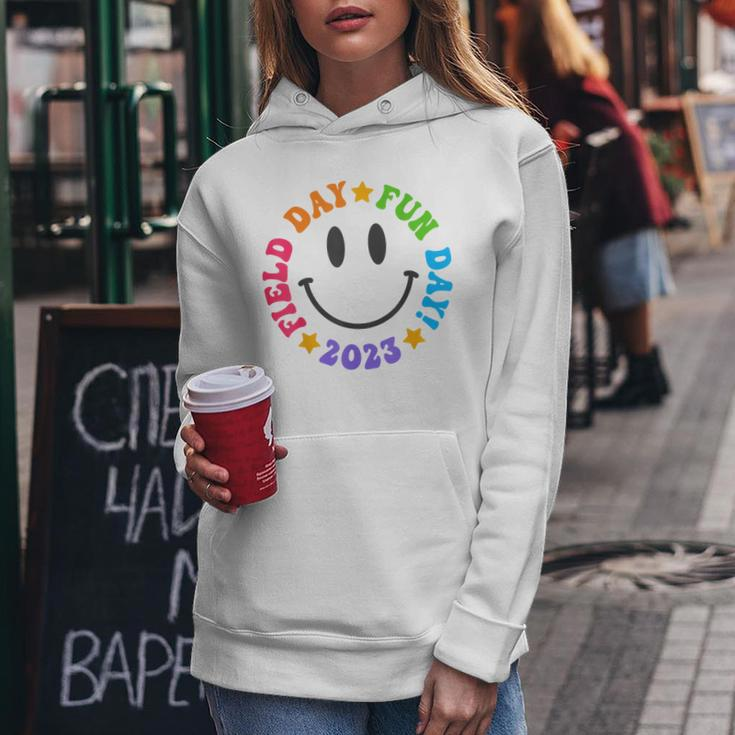 Field Day Fun Day 2023 Groovy Smile Face Funny Teacher Kids Women Hoodie Personalized Gifts