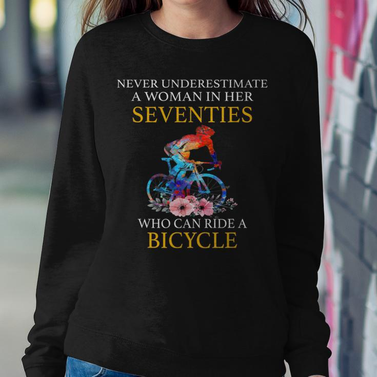 Never Underestimate Woman In Her Seventies Rides A Bicycle Women Sweatshirt Funny Gifts