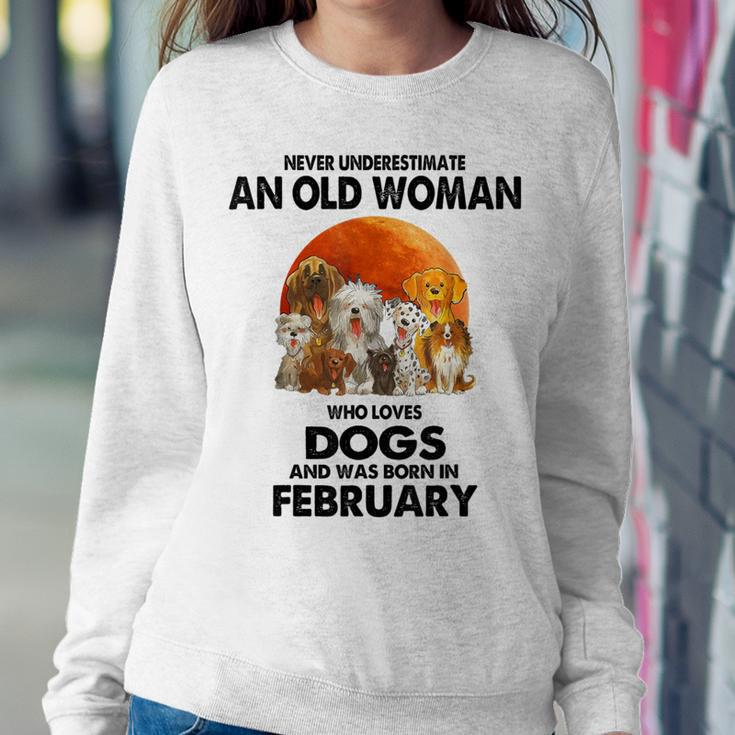 Never Underestimate An Old Woman Who Loves Dogs February Women Sweatshirt Personalized Gifts
