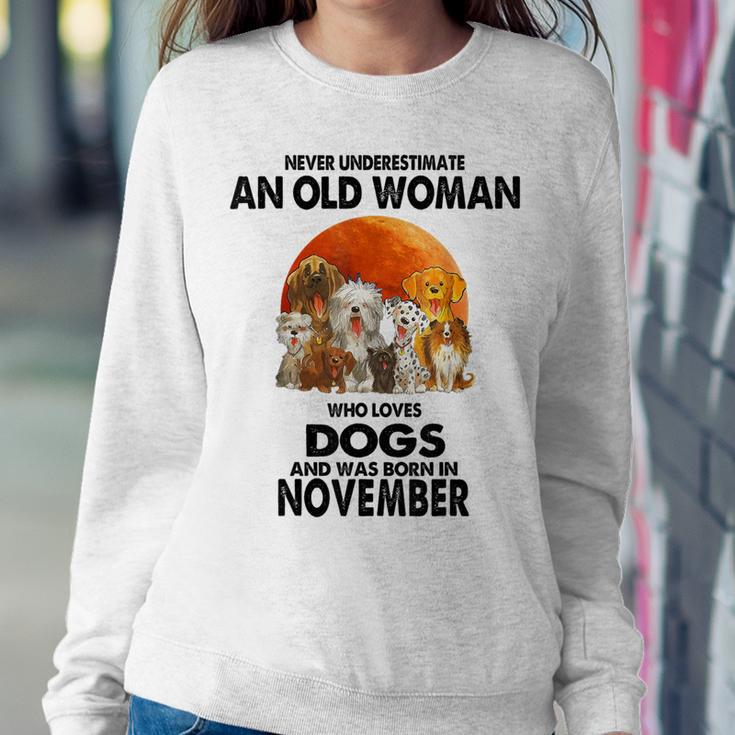 Never Underestimate An Old Woman Who Loves Dogs November Women Sweatshirt Personalized Gifts