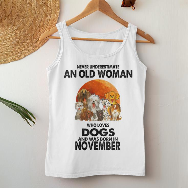 Never Underestimate An Old Woman Who Loves Dogs November Women Tank Top Personalized Gifts