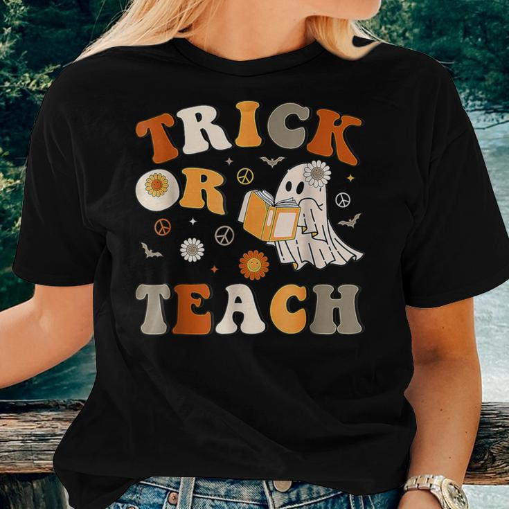 Trick Or Teach Groovy Halloween Retro Floral Ghost Teacher Women T-shirt Gifts for Her