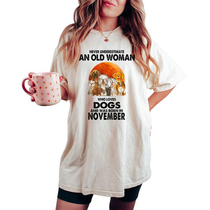 Never Underestimate An Old Woman Who Loves Dogs November Women's Oversized Comfort T-shirt