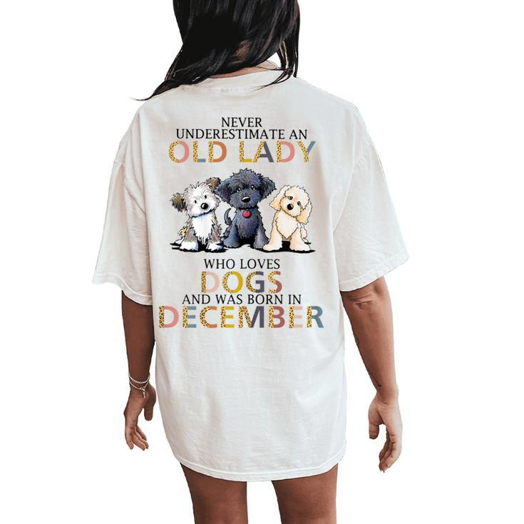 Never Underestimate Old Lady Loves Dogs Born In December Women's Oversized Comfort T-Shirt Back Print