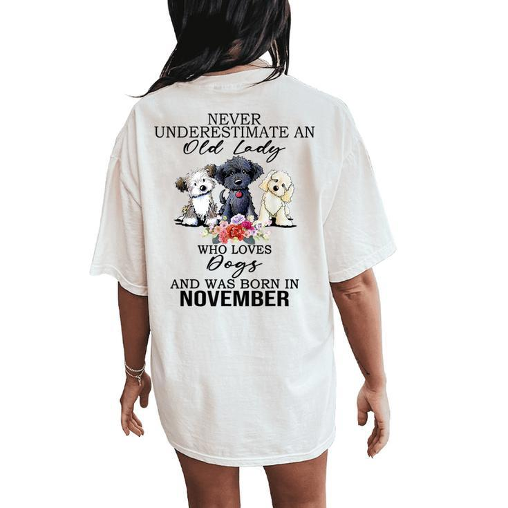 Never Underestimate An Old Lady Who Loves Dogs-November Women's Oversized Comfort T-Shirt Back Print