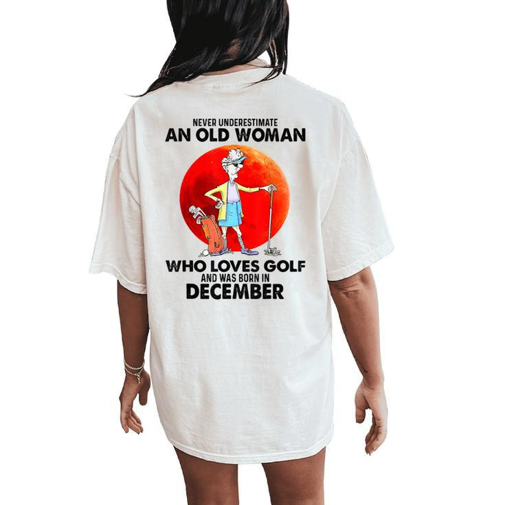 Never Underestimate An Old Woman Who Loves Golfs December Women's Oversized Comfort T-Shirt Back Print