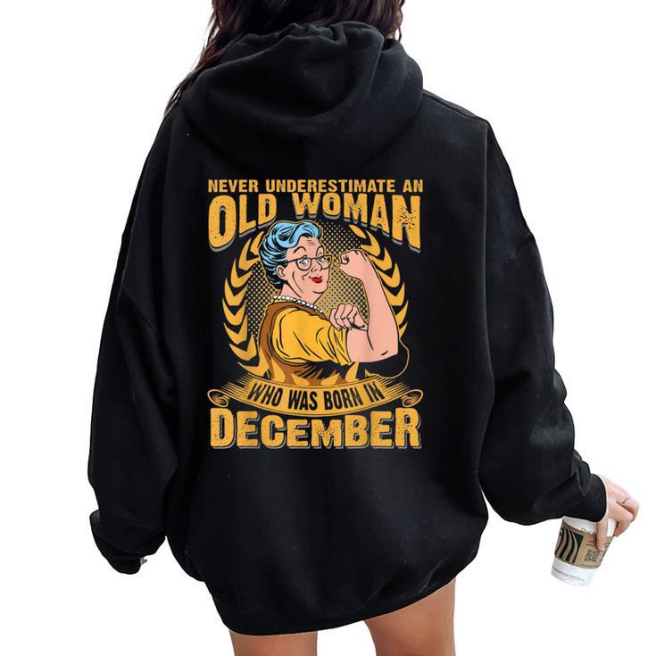 Never Underestimate An Old Woman Who Born In December Women Oversized Hoodie Back Print