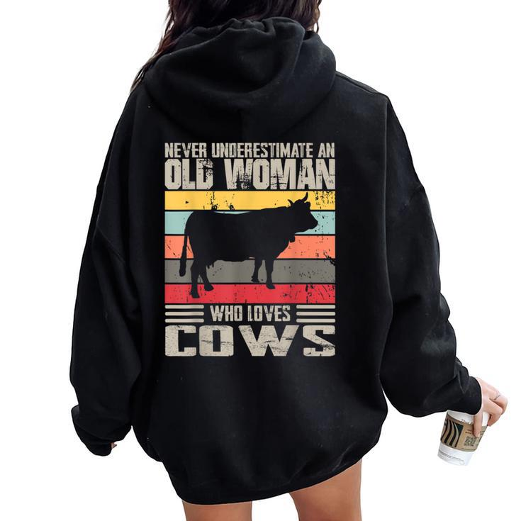 Vintage Never Underestimate An Old Woman Who Loves Cows Cute Women Oversized Hoodie Back Print