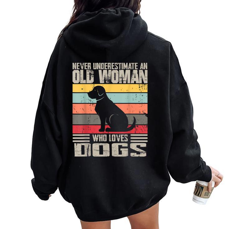 Vintage Never Underestimate An Old Woman Who Loves Dogs Cute Women Oversized Hoodie Back Print