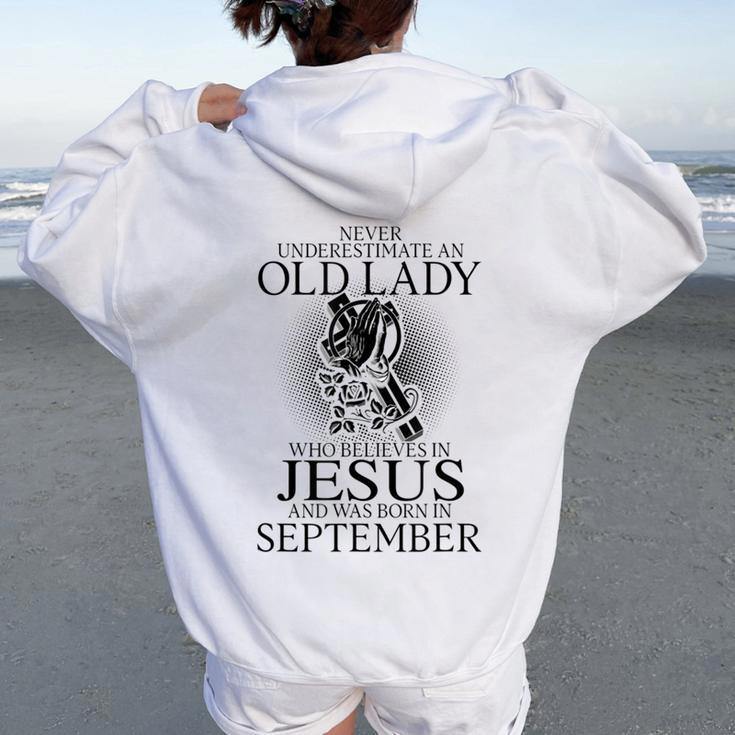 Never Underestimate An Old Lady Believes In Jesus September Women Oversized Hoodie Back Print