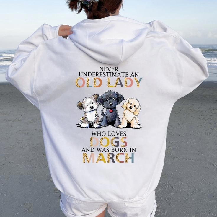Never Underestimate Old Lady Loves Dogs Born In March Women Oversized Hoodie Back Print