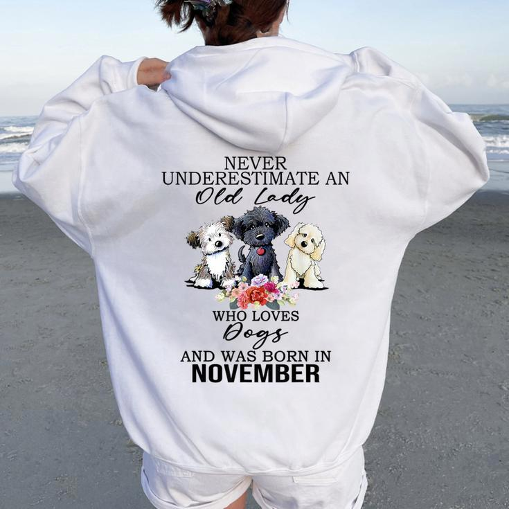 Never Underestimate An Old Lady Who Loves Dogs-November Women Oversized Hoodie Back Print