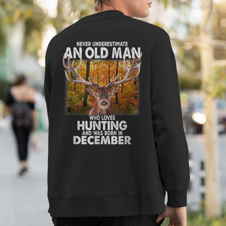 Never Underestimate A Man Loves Hunting Born In December Sweatshirt Back Print