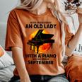 Never Underestimate An Old Lady With A Piano Born September Women's Oversized Comfort T-Shirt Yam