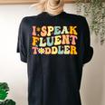 Groovy I Speak Fluent Toddler Daycare Provider Teacher Women's Oversized Comfort T-shirt Back Print Black